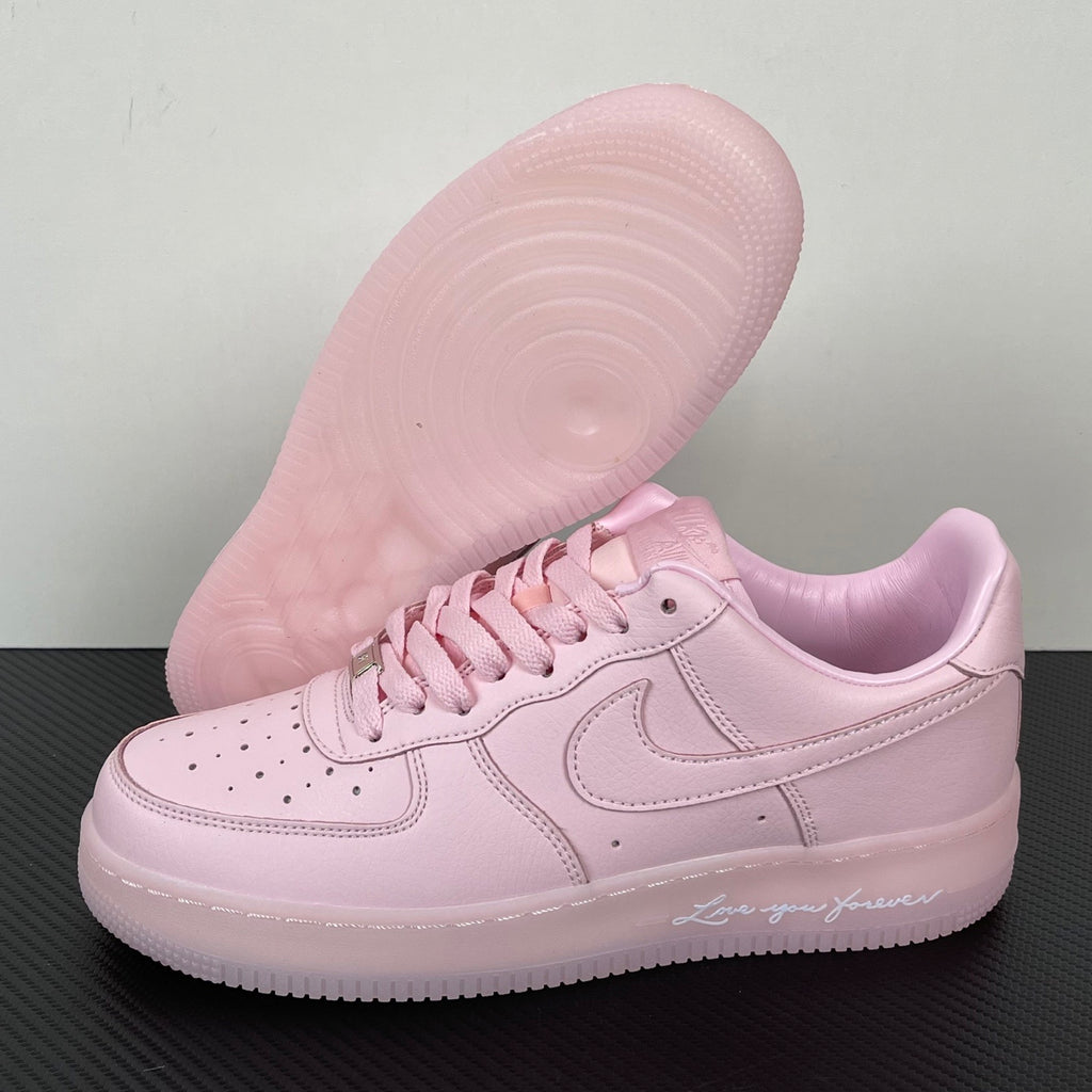 Pink low-top sneakers with visible outsole tread and lace-up upper