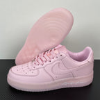 Pink low-top sneakers with visible outsole tread and lace-up upper