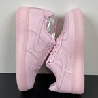 Pink low-top sneakers with lace-up front and swoosh on side