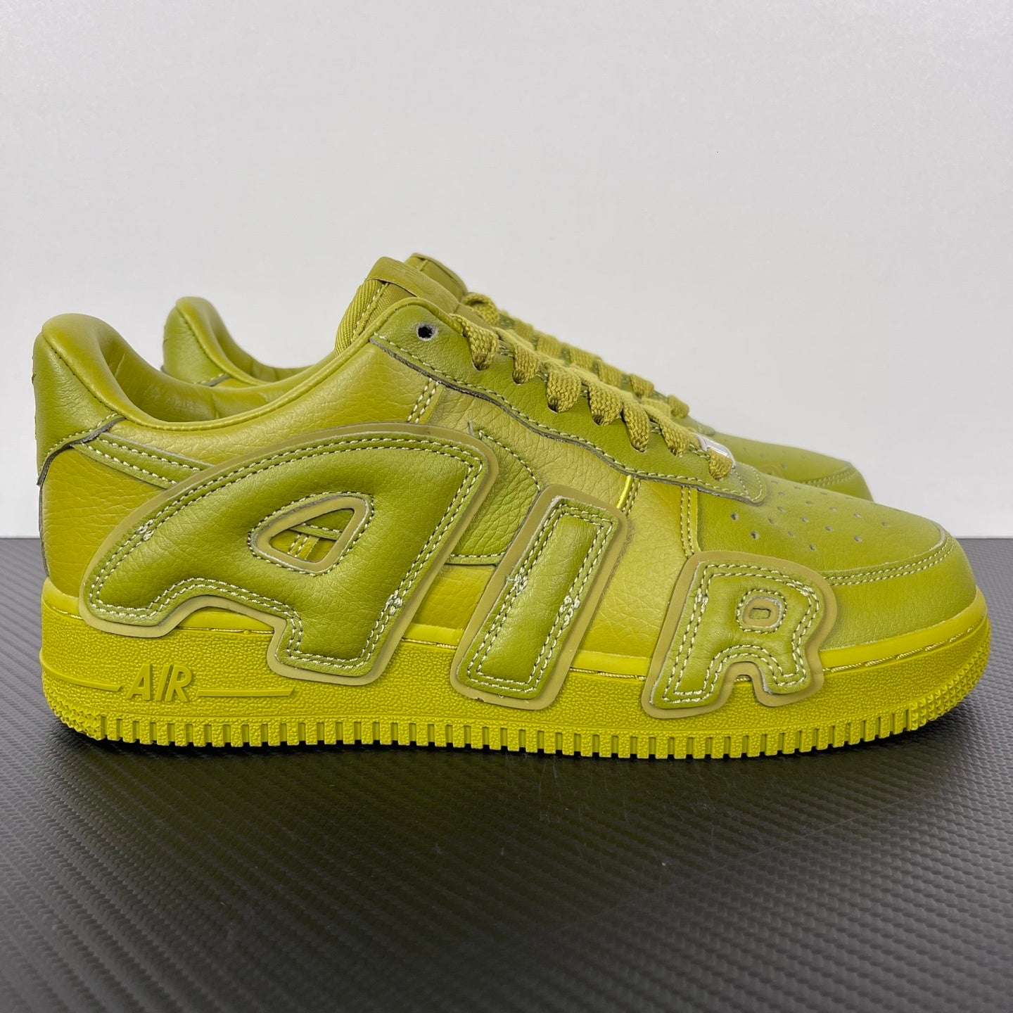 Lime green leather Air Force 1 sneakers with side panels, lace eyelets, Air branding