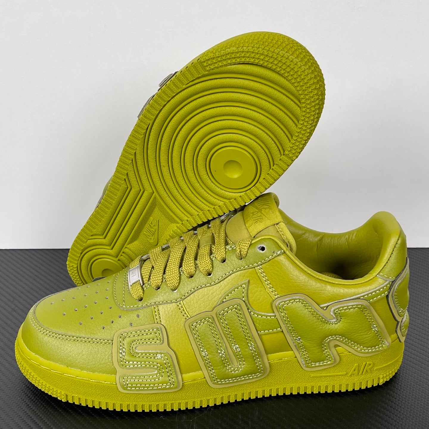 Lime green Air Force 1 sneaker with visible outsole tread and lace-up upper