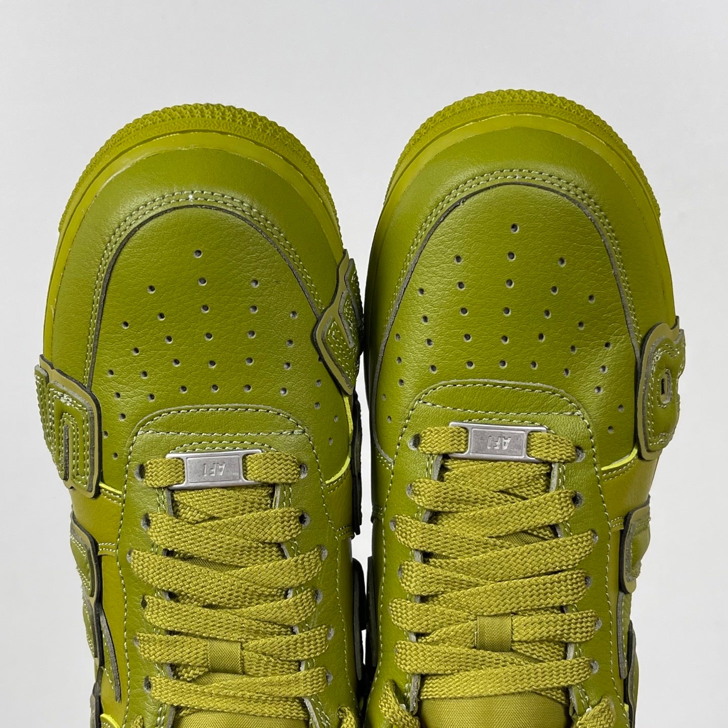 Lime green Air Force 1 sneakers, top view of toe box and lace-up closure