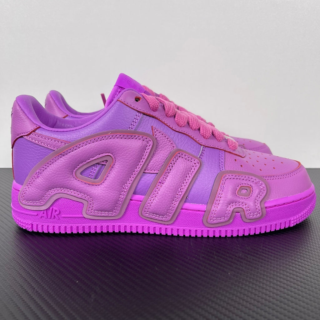 Purple Nike Air Force 1 sneakers with pink laces and bold “AIR” logo detail