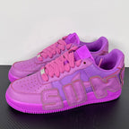 Purple Nike Air Force 1 sneakers, angled front view with pink laces