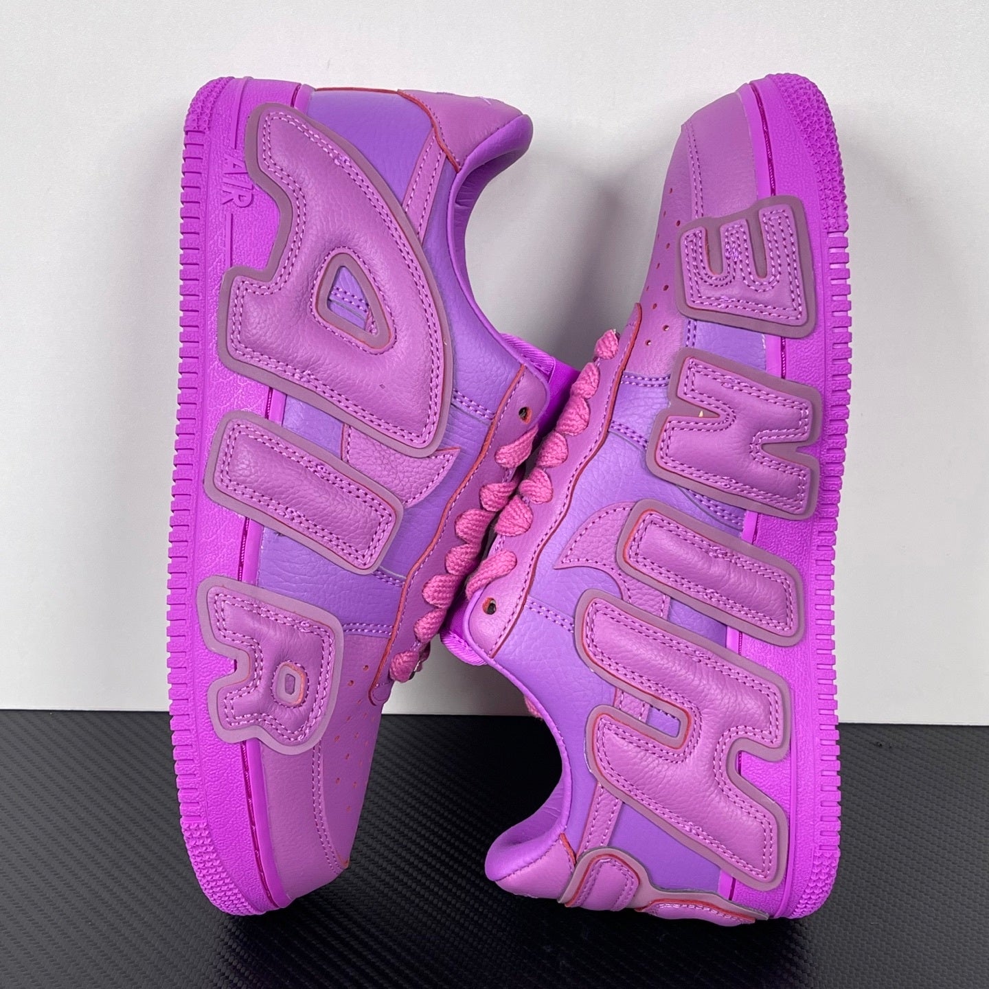 Purple Nike Air Force 1 sneakers, rear view showing heel cushioning and logo